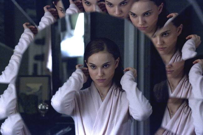 Nina adjusts her hair while multiple mirror panels fragment and repeat her reflection.