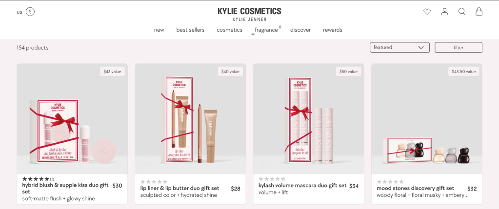 Four Kylie Cosmetics gift sets displayed on the brand’s website in coordinated pink, white, nude, and red packaging.